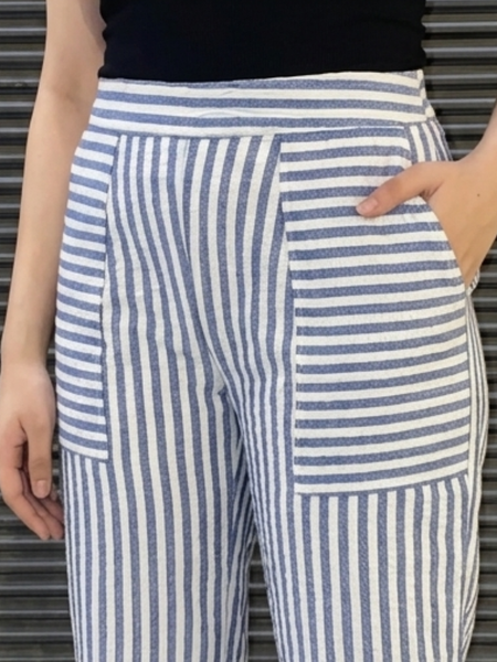 Model wearing white blue striped casual folded hem pants