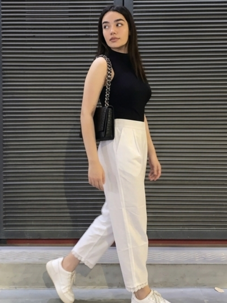 Close-up of lace detailing on white palazzo hem