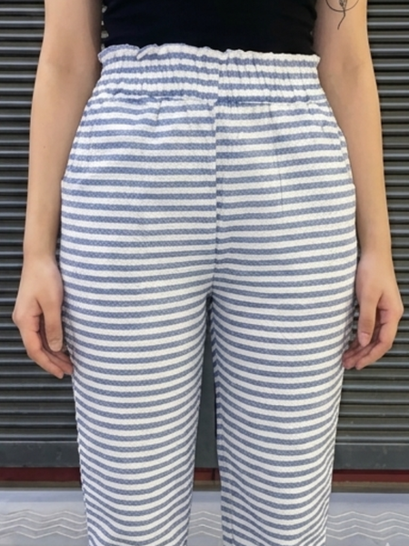 Model wearing white blue striped casual cotton pants