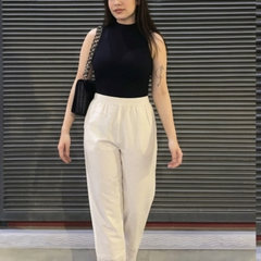 Close-up of lace hem detail on white palazzo